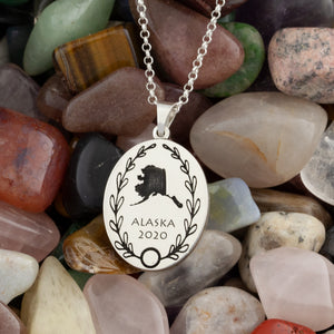 Personalized oval necklace engraved with country or state outline